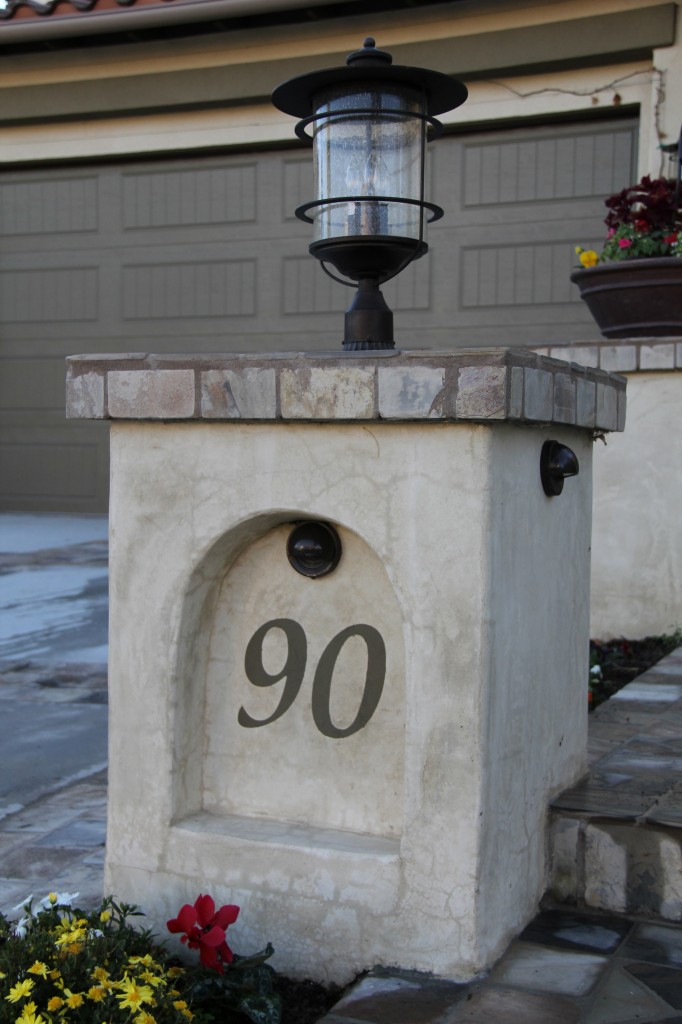 arched pilaster with house number stenciled on