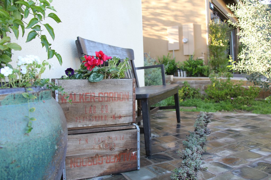 old vegetable wooden crates double as flower planter