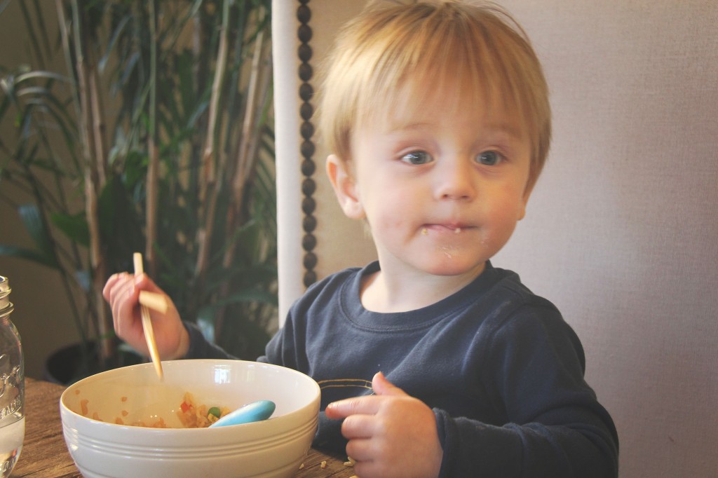 toddler eating friend rice with chopsticks