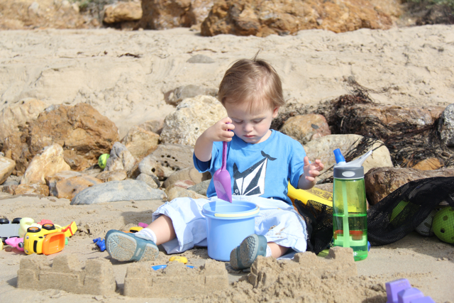 toddler digging in the sand