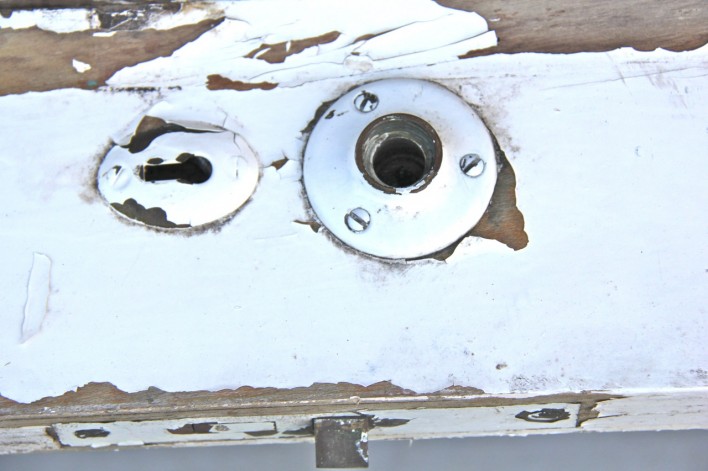 chippy paint antique door hardware close up