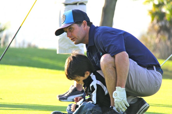 Dad and son on golf course
