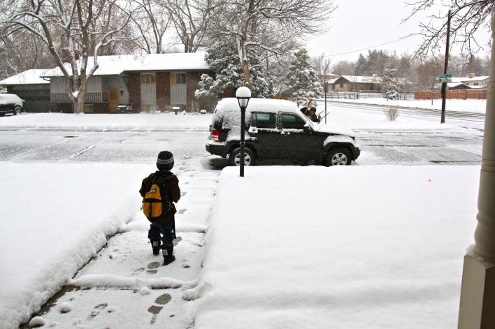 snowy walkway with walking boy