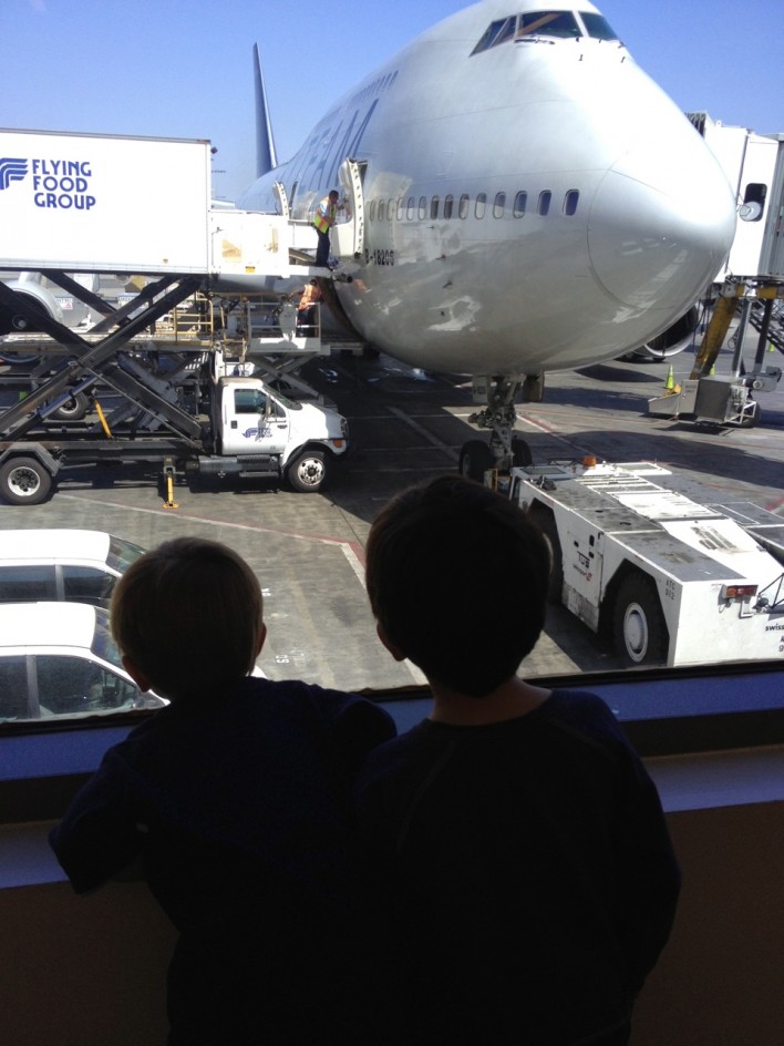 young boys looking at airplane