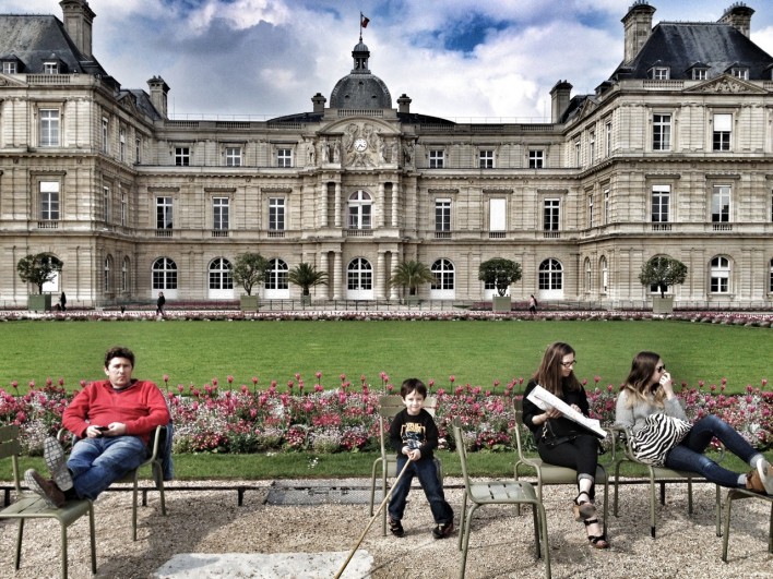 boy standing in front of French Senate at Jardin du Luxembourg