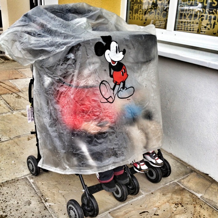 Mickey Mouse poncho over a stroller