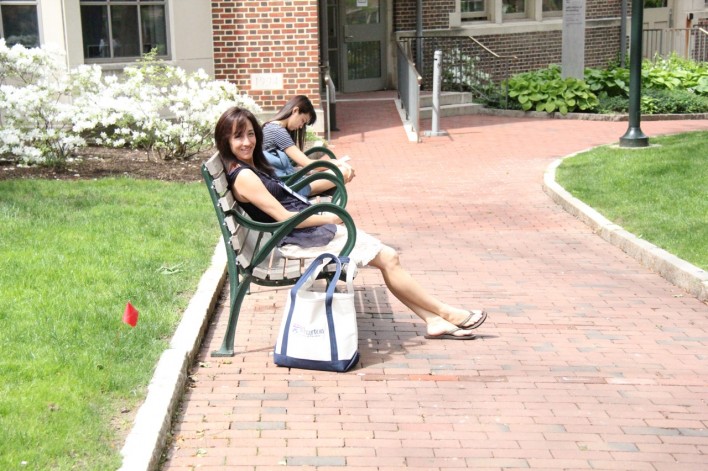 women sitting on bench in college
