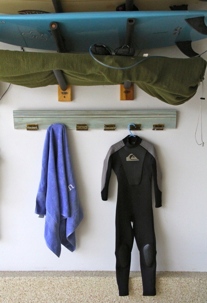 Annie Sloan coat rack under a surfboard rack with a wetsuit