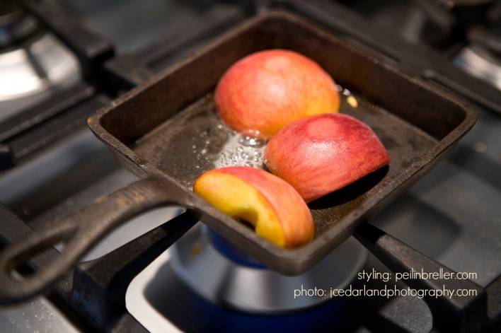 butter sauteed peaches in an iron skillet