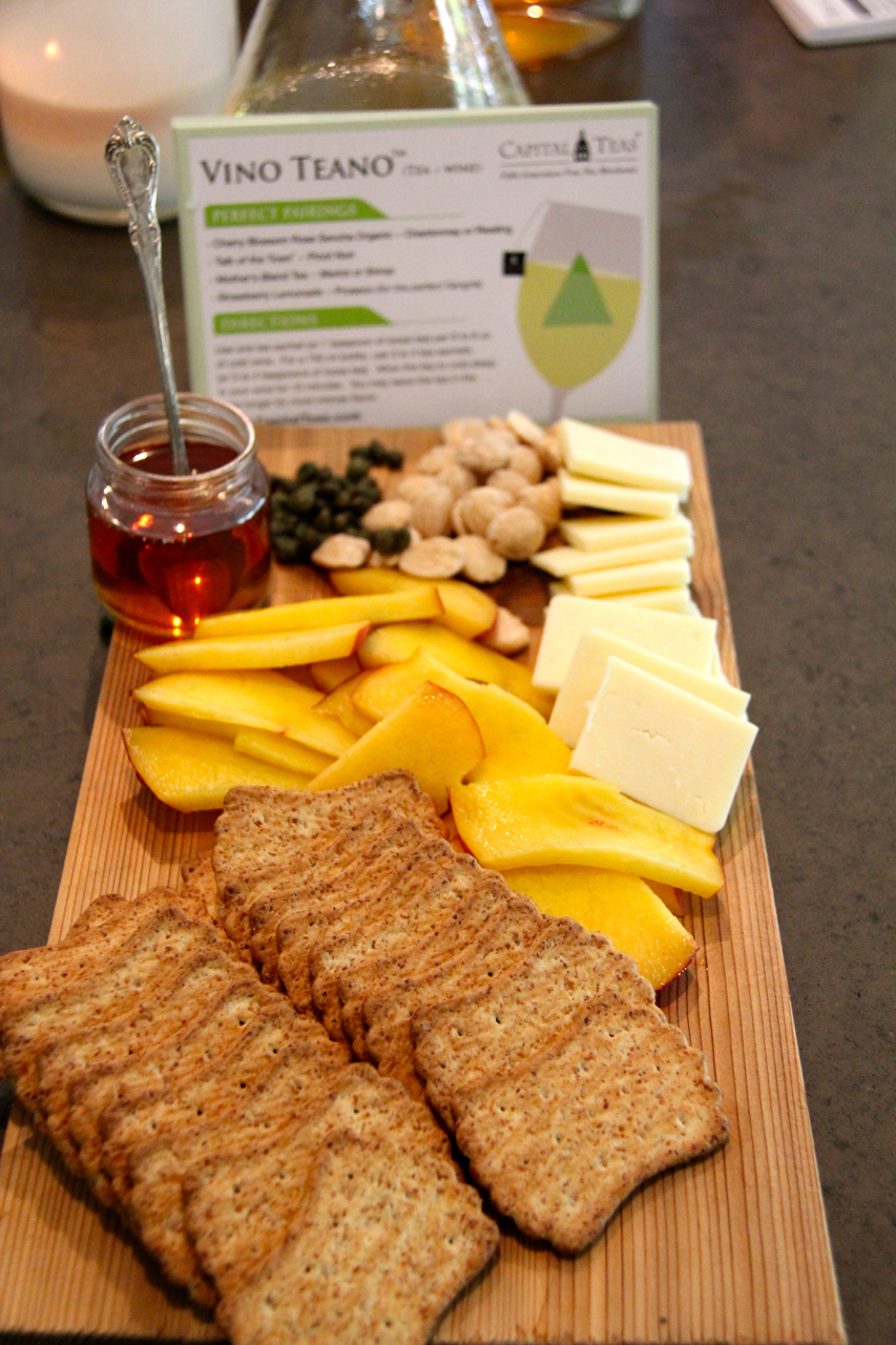 appetizer board with bread, peaches, honey, almonds and havarti