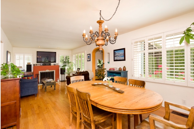 spanish cottage dining room with wood chandelier