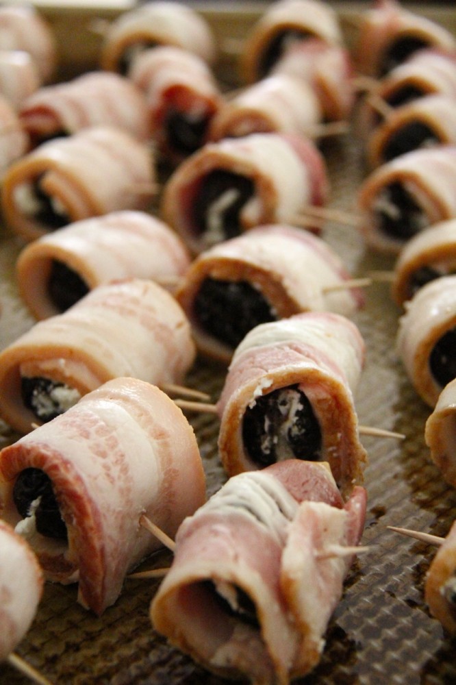 feta stuffed dates wrapped in bacon on baking sheet