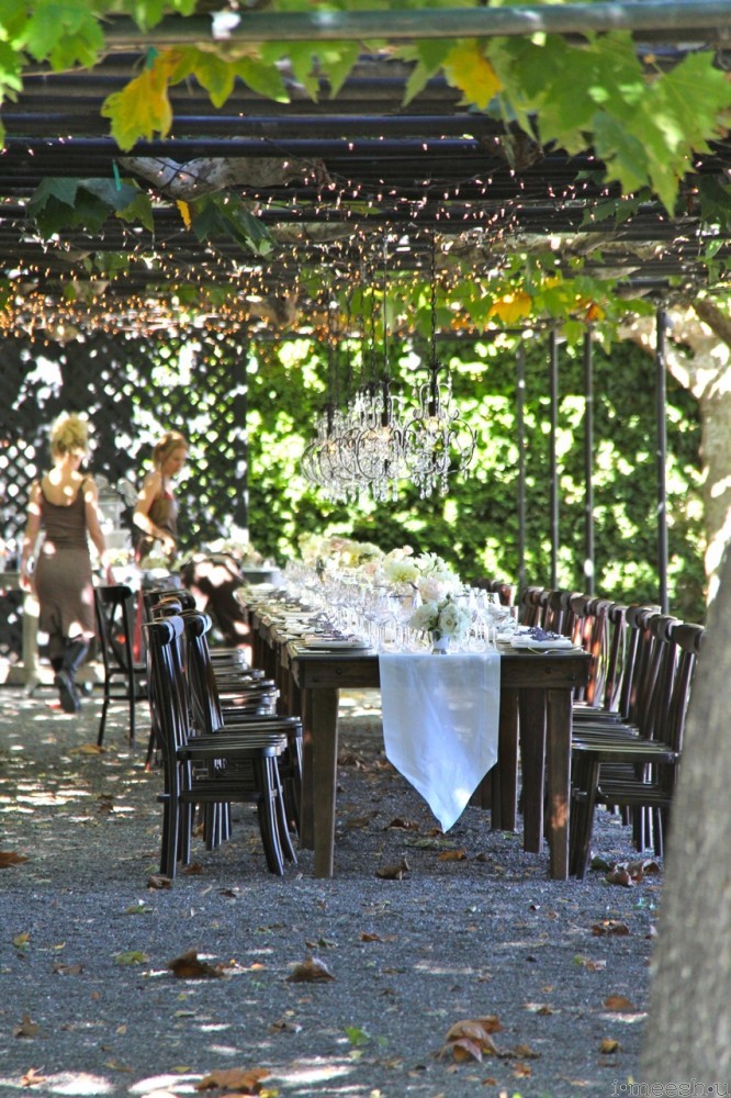 gorgeous outdoor Napa wedding table setting under wood arbor and sycamore trees