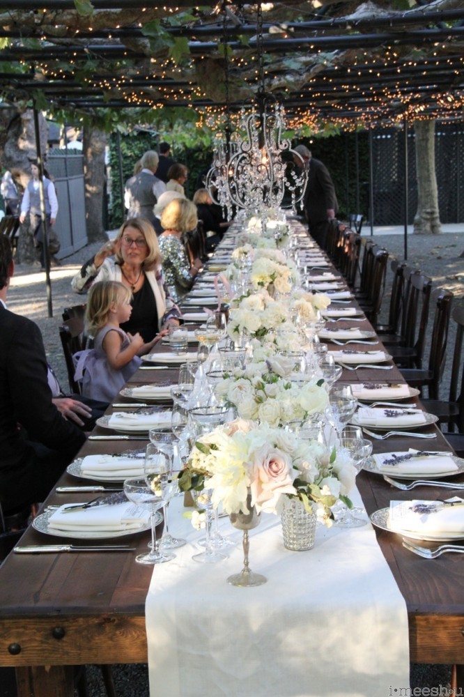 long family style dinner tables at evening wedding setting at Beaulieu Gardens Napa