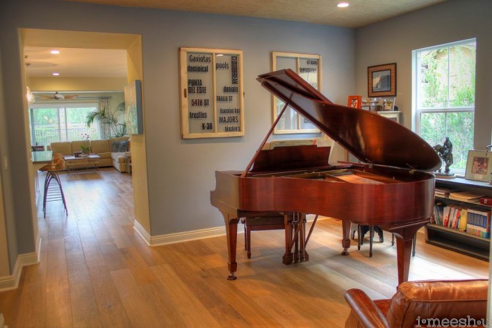 music room with walnut vintage grand piano