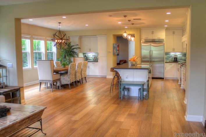 great room with provenza rustic wood floors leading into large kitchen and dining area