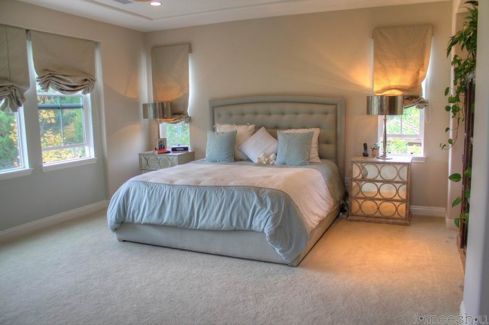 master bedroom with custom tufted nailhead bed