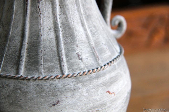 close up of shabby painted metal urn