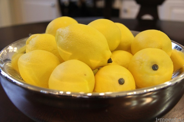 fresh lemons in silver bowl