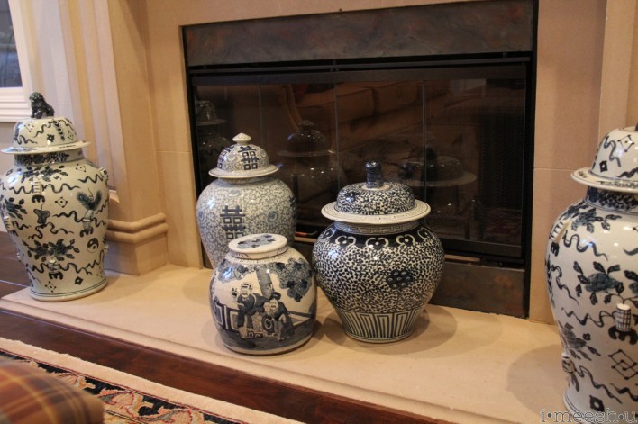 blue and white asian vases on traditional fireplace hearth