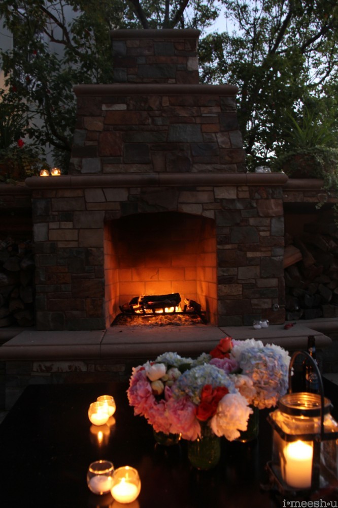 outdoor fireplace with hyndrangeas and candles
