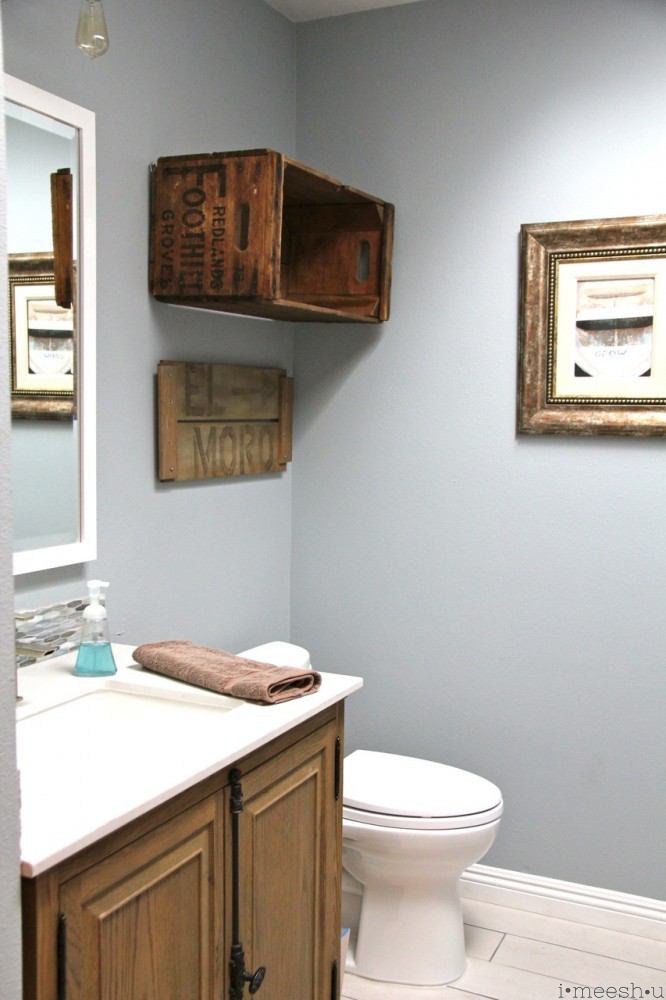 toilet with rustic wood crate to hold towels
