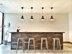 rustic weathered wood bar with metal barstools and 4 pendants